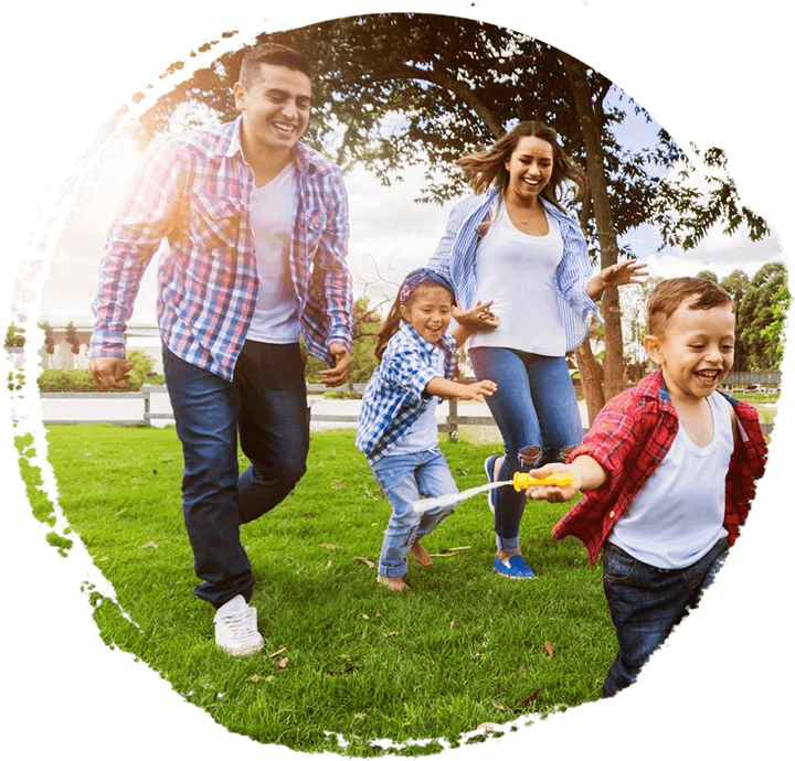 Happy family at the park enjoying a sunny day playing