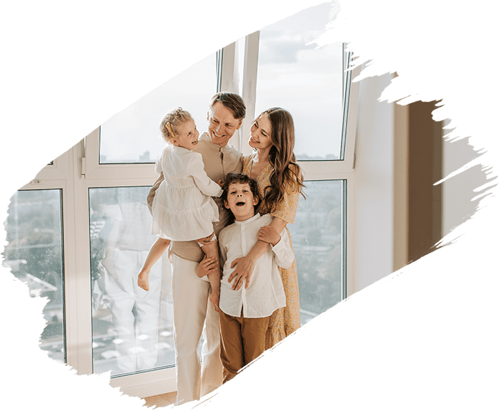 Happy family standing on windowsill together